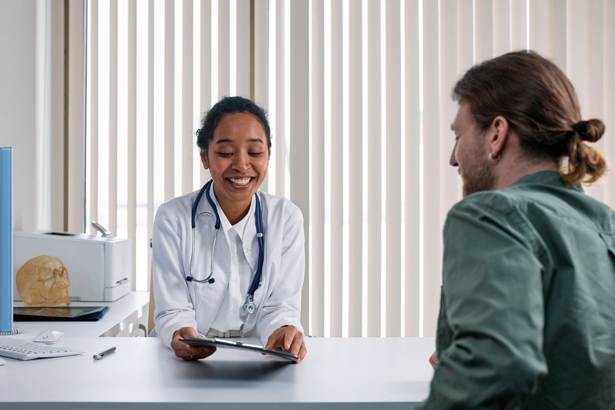 Physician speaking kindly with an elderly patient